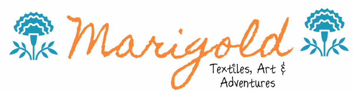 Logo of Marigold Textiles, Art & Adventures featuring a stylized flower on the left and the name 'Marigold' in an artistic font.